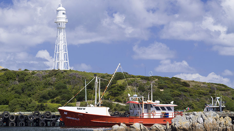 Fishing Boat and Lighthouse. Currie, King Island, Tasmania, Australia